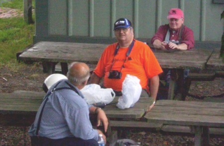 Things seem to be winding down as (L-R) James Leasure, Jim Mastromatteo and Denny Romain wait for another train.