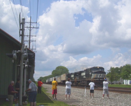 The photo has formed to record an eastbound Norfolk Southern intermodal train pass the Olmsted Falls station. 
