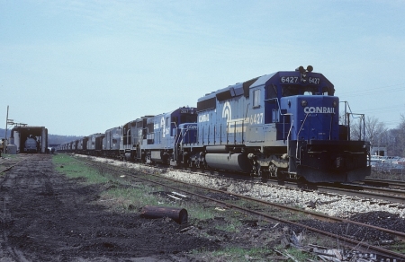 In one of the more interesting trains to pass through Kent, 12 dead GG1 electrics sit at the Summit Street crossing on the former EL in April 1979. They were bound for a scrapper in Hubbard, Ohio. That’s the tank car lining building in the background.