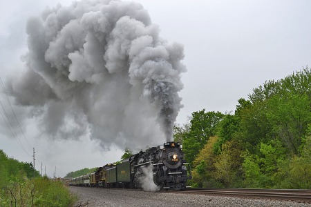 Billowing smoke fills the air as the Nickel Plate Road No. 765 passes Dewey Road in Amherst on Saturday.