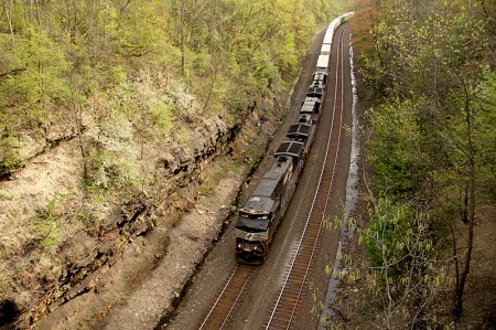 A westbound intermodal grinds its way through Highland Cut. Note the flowering trees on the side of the cut on the fireman's side of the lead locomotive.