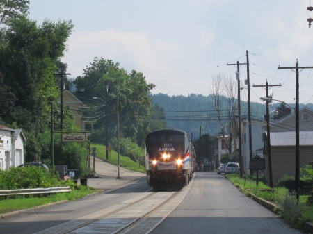 The "Coal Goes to War" special navigates the street running in West Brownsville, Pa. When the trip was announced it was supposed to have been pulled by E units painted in Pennsylvania Railroad markings.  But the motive power was changed to an Amtrak heritage unit.