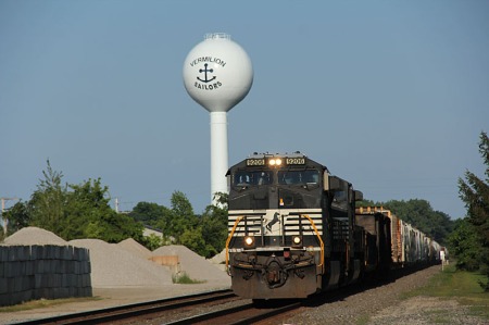 A westbound manifest freight passes the iconic Vermilion water tower in a view taken from the former Vermilion New York Central passenger station.