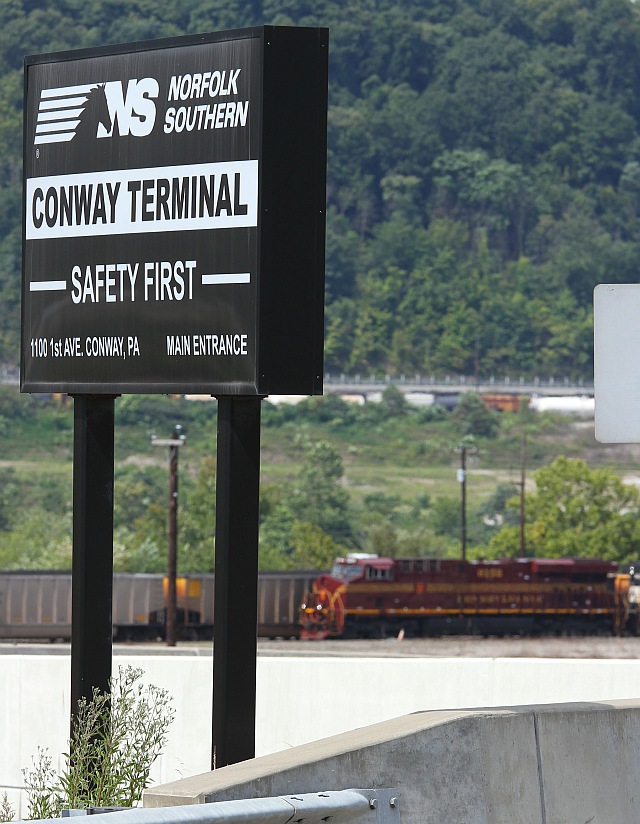 The sign says Norfolk Southern . . . but what's that Tuscan unit off in the distance?