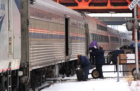 Two Cleveland Amtrak agents load and unload baggage from the Boston baggage car of 448. 