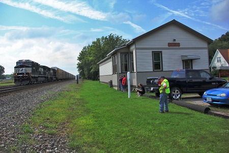 An eastbound Norfolk Southern train has everyone's attention at the former Pennsylvania Railroad station in Sebring, the home of a model railroad club. 