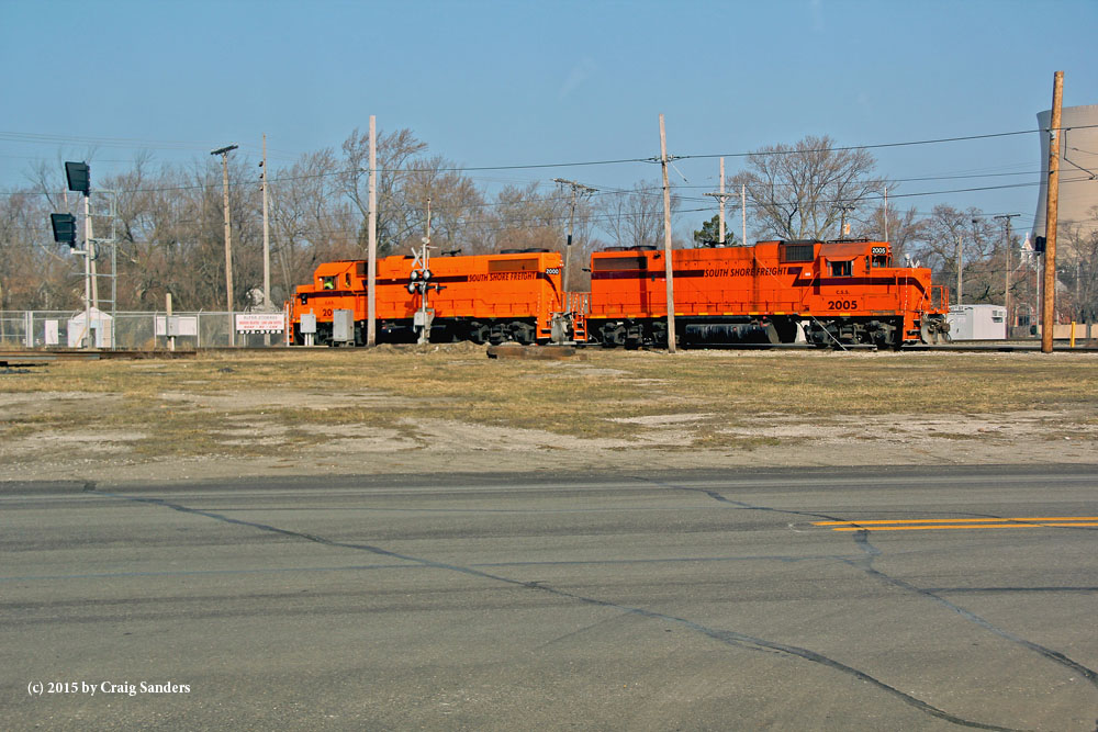 The signals at the left edge of the image was the eastward home signals for Amtrak's Michigan District, which crosses the South Shore on a diamond on the edge of 10th Street. 