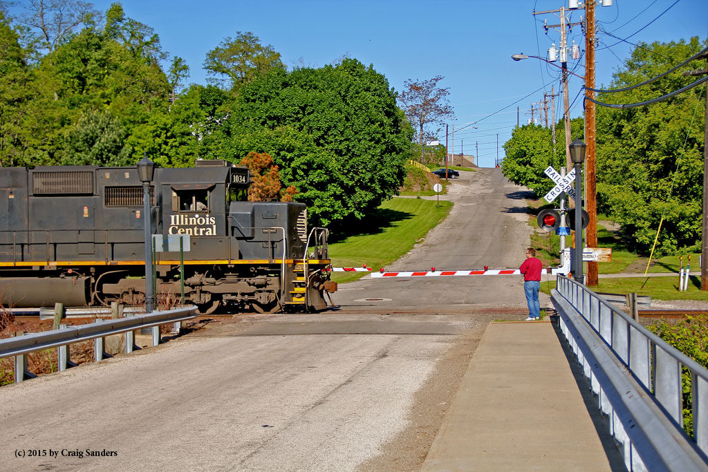 Illinois Central 1034 leads a coal train into Conneaut in a view looking west on Old Main Street.
