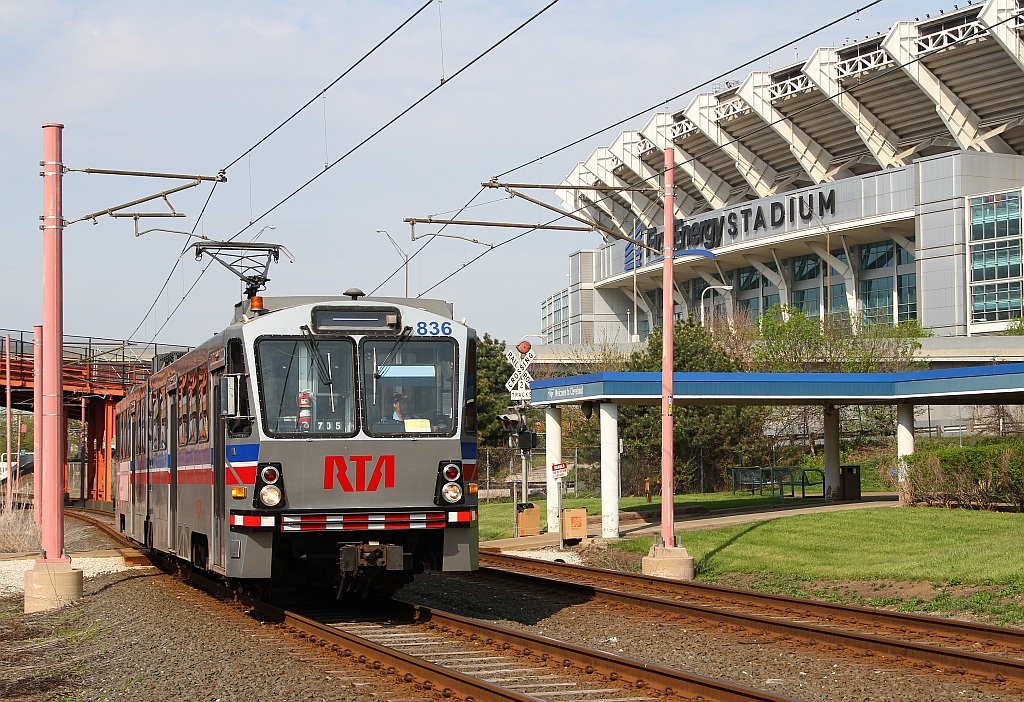 A Waterfront line RTA car cruises past the Cleveland Amtrak Station and  in the background) First Energy Field.