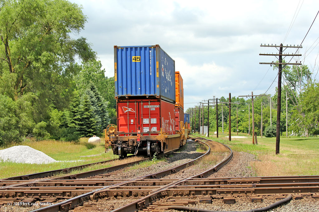 A colorful set of red and blue containers brings up the rear of a Detroit-bound stack train.