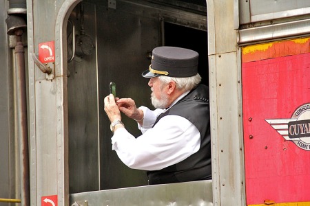 A CVSR trainman photographs the NKP 765 as it passes by in Peninsula.