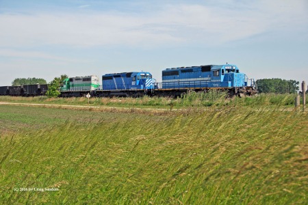A wider perspective of the array of liveries on the motive power consist of the W&LE stone train sitting near Bellevue.