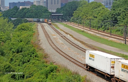 Here comes NS train 310 as the last containers of train 206 clear.