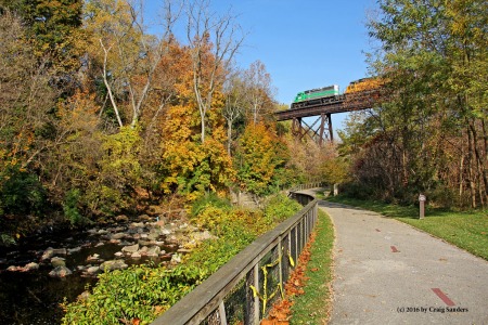 A Wheeling & Lake Erie stone train takes head room on the trestle spanning the valley of the Ohio & Erie Canal.