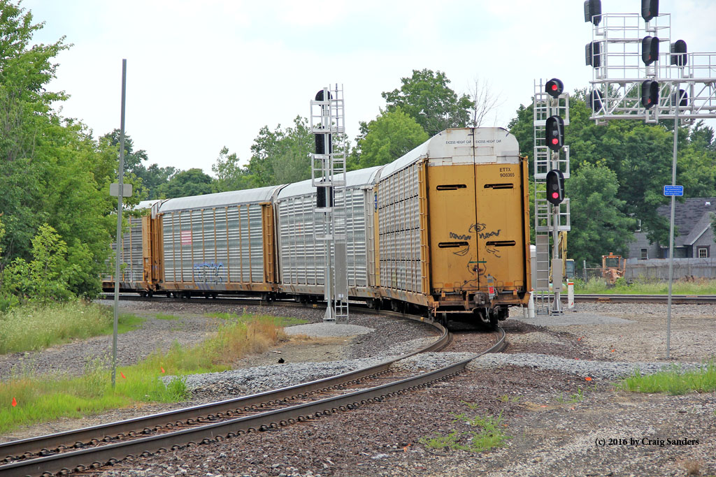A cut of auto racks clears the signals on the Chicago wye in Durand.